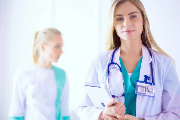 Retrato de una joven doctora, con almohadillas en la mano, en un consultorio médico —  Fotos de Stock