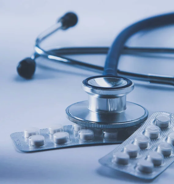 Stethoscope, pills on light background. medicine concept — Stock Photo, Image