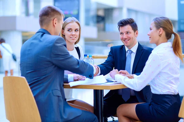 Group of happy young business people in a meeting at office. Group of happy young business — Stock Photo, Image
