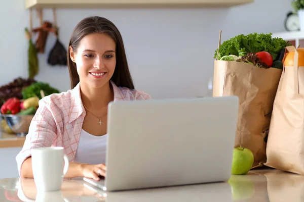 Lächelnde Frau beim Online-Shopping mit Tablet und Kreditkarte in der Küche. Lächelnde Frau — Stockfoto