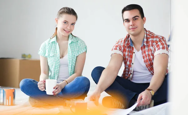 Young couple sitting on floor and calculating about they savings. Young couple — Stock Photo, Image