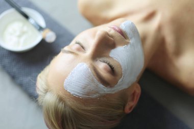 Yüz maskesi. Güzel genç kız Spa, makyajcısı kadın yüz maskesi uygulama.