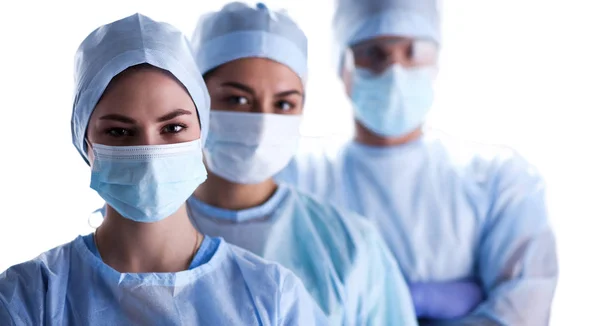 Equipe de cirurgiões, usando uniformes protetores, bonés e máscaras — Fotografia de Stock
