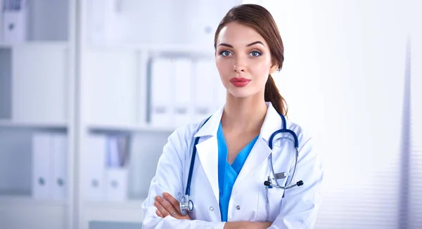 Portrait of young woman doctor with white coat standing in hospital — Stock Photo, Image