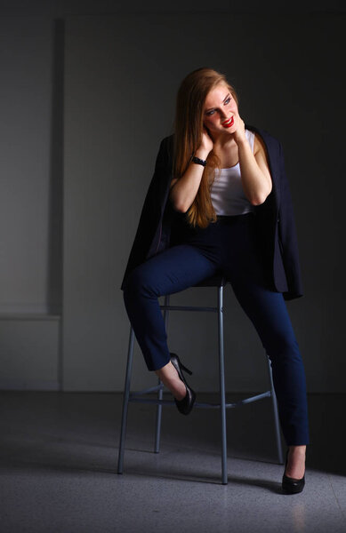 Young woman sitting on a chair . Young woman
