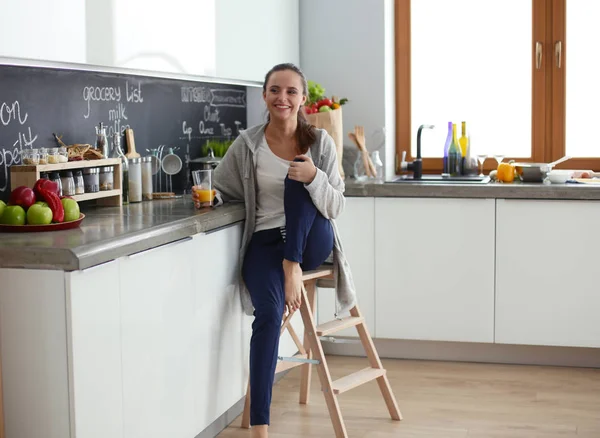 Woman in the kitchen. Cooking at kitchen.