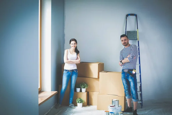 Portrait happy smiling young couple painting interior wall of new house. Young couple — Stock Photo, Image