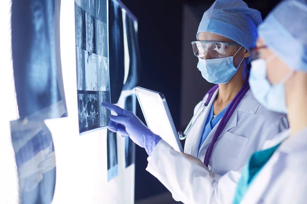 Two female women medical doctors looking at x-rays in a hospital. — Stock Photo, Image