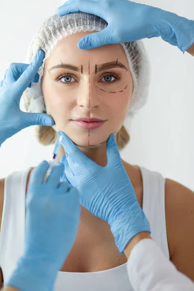 Mooie vrouw gezicht in de buurt van arts met spuit. — Stockfoto