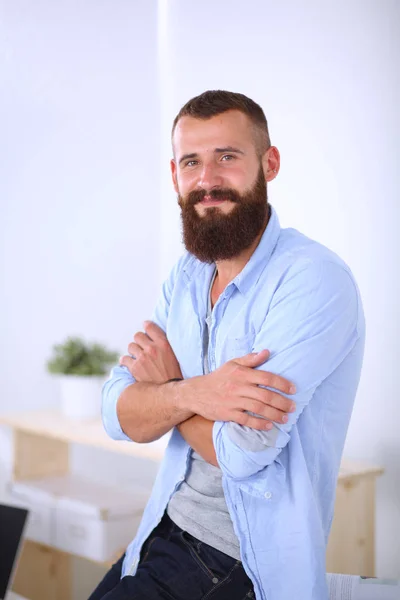 Handsome businessman standing in office on grey background — Stock Photo, Image