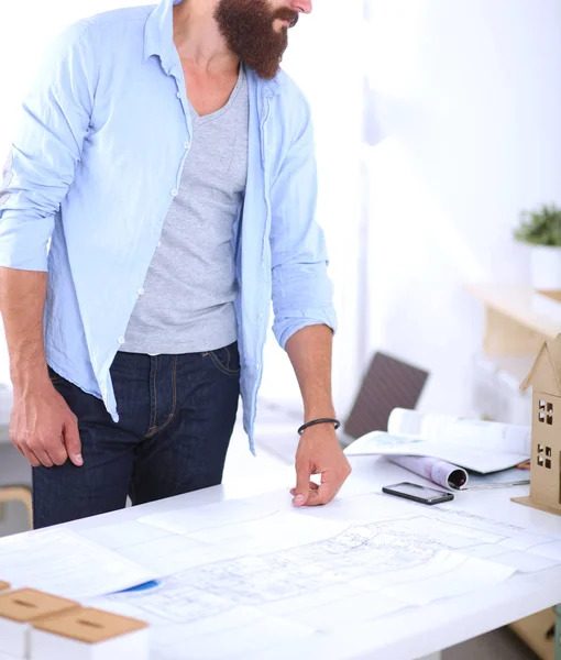 Handsome businessman standing in office on grey background — Stock Photo, Image