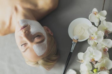 Yüz maskesi. Güzel genç kız Spa, makyajcısı kadın yüz maskesi uygulama.