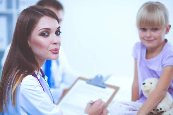 Female doctor examining child with stethoscope at surgery — Stock Photo, Image