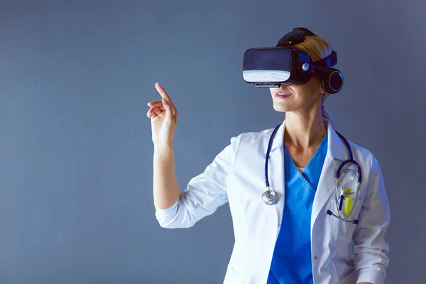 Female doctor wearing virtual reality glasses isolated on white background.