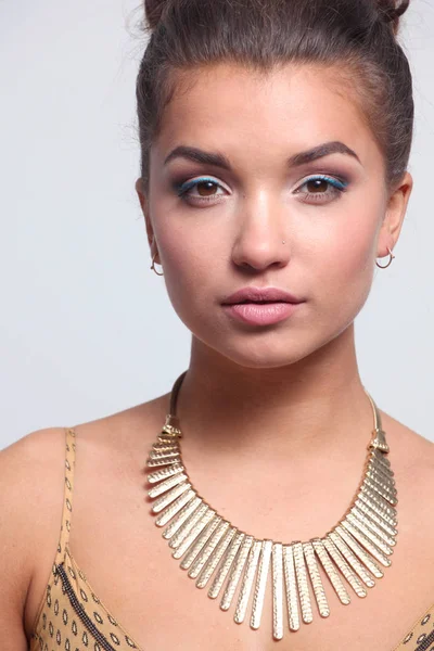 Young beautiful brunette woman with beads. Young beautiful brunette — Stock Photo, Image