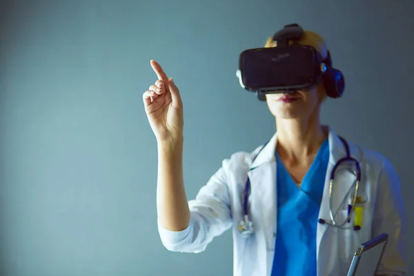 Female doctor wearing virtual reality glasses isolated on white background.