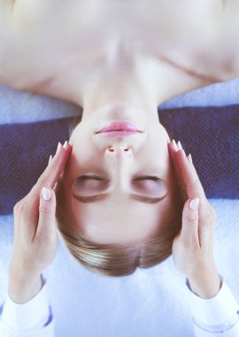 Masaj masasında uzanmış gözleri kapalı rahatlayan genç bir kadın. - Kadın. Spa salonu