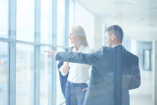 Portrait of young businessman in office with colleagues in the background . Portrait of young businessman. — Stock Photo, Image