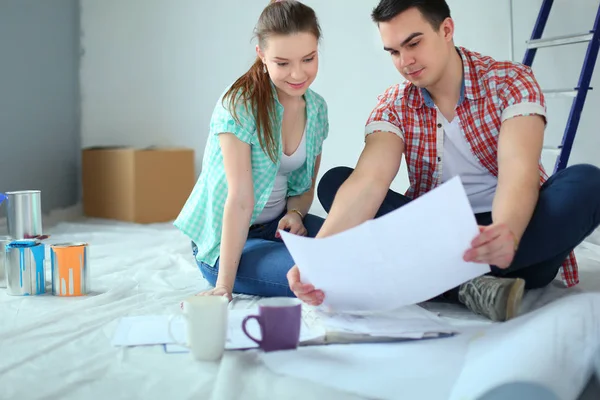 Young couple sitting on floor and calculating about they savings. Young couple — Stock Photo, Image
