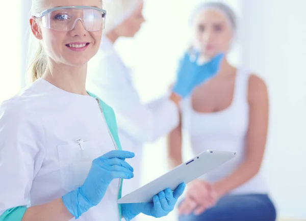 Beautiful woman face near doctor with syringe. — Stock Photo, Image