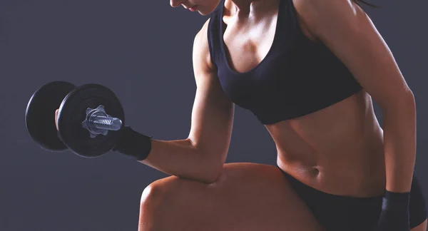 Muscular young woman standing on gray background. Muscular young woman. beautiful girl pumps muscles — Stock Photo, Image