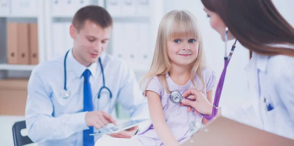 Female doctor examining child with stethoscope at surgery — Stock Photo, Image