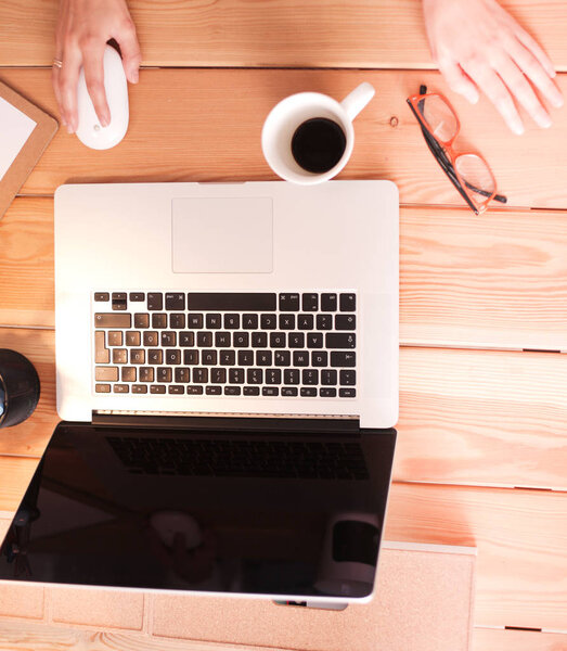 Young female working sitting at a desk.