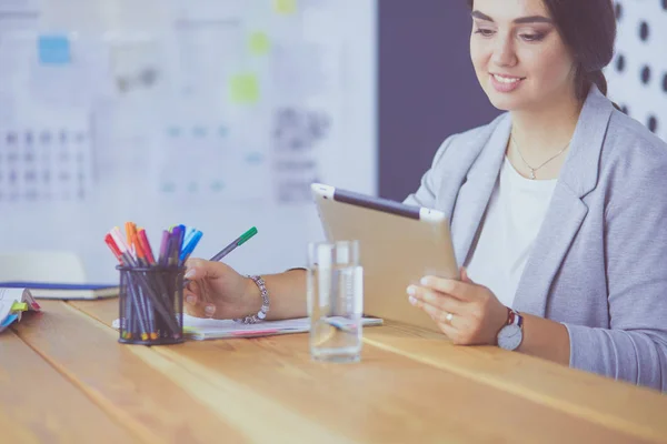 Pretty young female manager using modern digital tablet at office — Stock Photo, Image