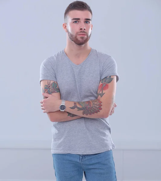 Portrait of a happy casual man standing isolated on a dark background — Stock Photo, Image