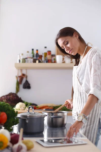 Cooking woman in kitchen with wooden spoon. Cooking woman — Stock Photo, Image