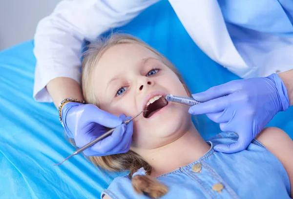 Niña sentada en el consultorio de dentistas. — Foto de Stock