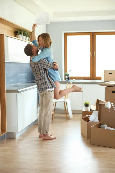Portrait of young couple moving in new home. Young couple