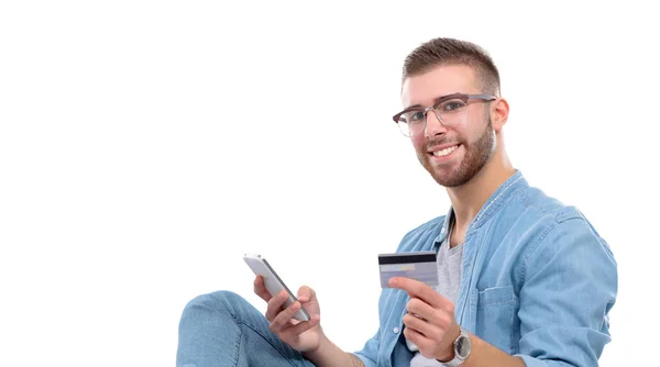 Młody mężczyzna siedzi na krześle i posiadania karty kredytowej. Startupper. Młody przedsiębiorca. — Zdjęcie stockowe