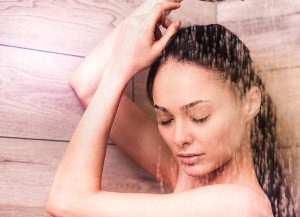 Young beautyful woman under shower in bathroom — Stock Photo, Image