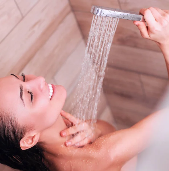 Young beautyful woman under shower in bathroom — Stock Photo, Image