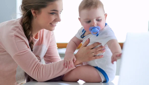 Mother with her baby in the bright kitchen at home. — Stock Photo, Image