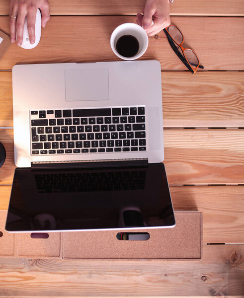 Young female working sitting at a desk.