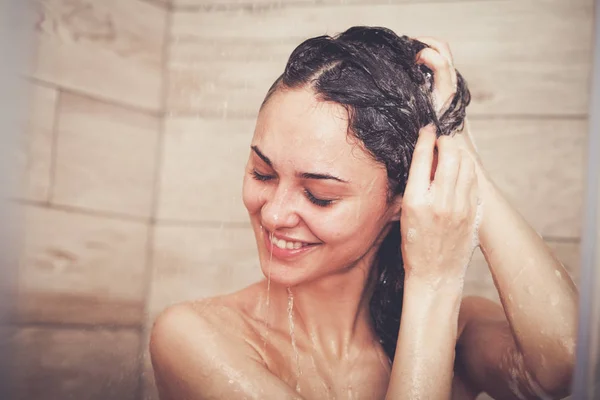 Jonge beautyful vrouw onder de douche in de badkamer — Stockfoto