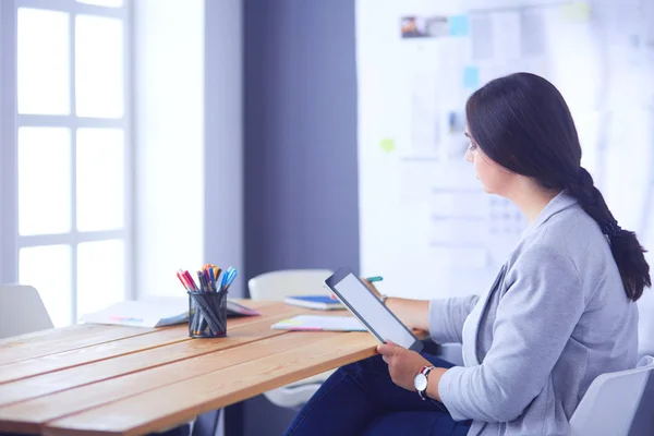 Pretty young female manager using modern digital tablet at office. — Stock Photo, Image