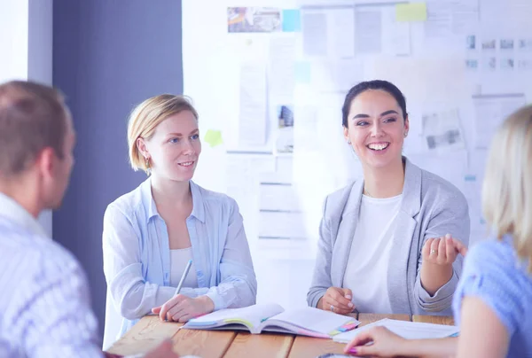 Young people studying with books on desk. Beautiful women and men working together. — Stock Photo, Image