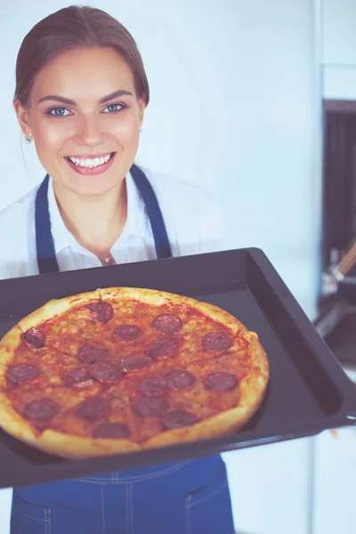 Happy young woman cooking pizza at home — Stock Photo, Image