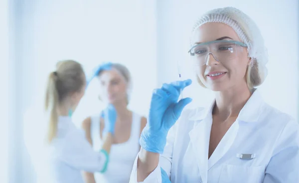 Beautiful woman face near doctor with syringe. — Stock Photo, Image