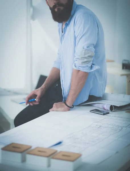 Portrait of male designer in hat with blueprints at desk — Stock Photo, Image