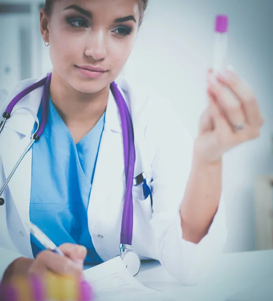 Woman researcher is surrounded by medical vials and flasks, isolated on white background — Stock Photo, Image