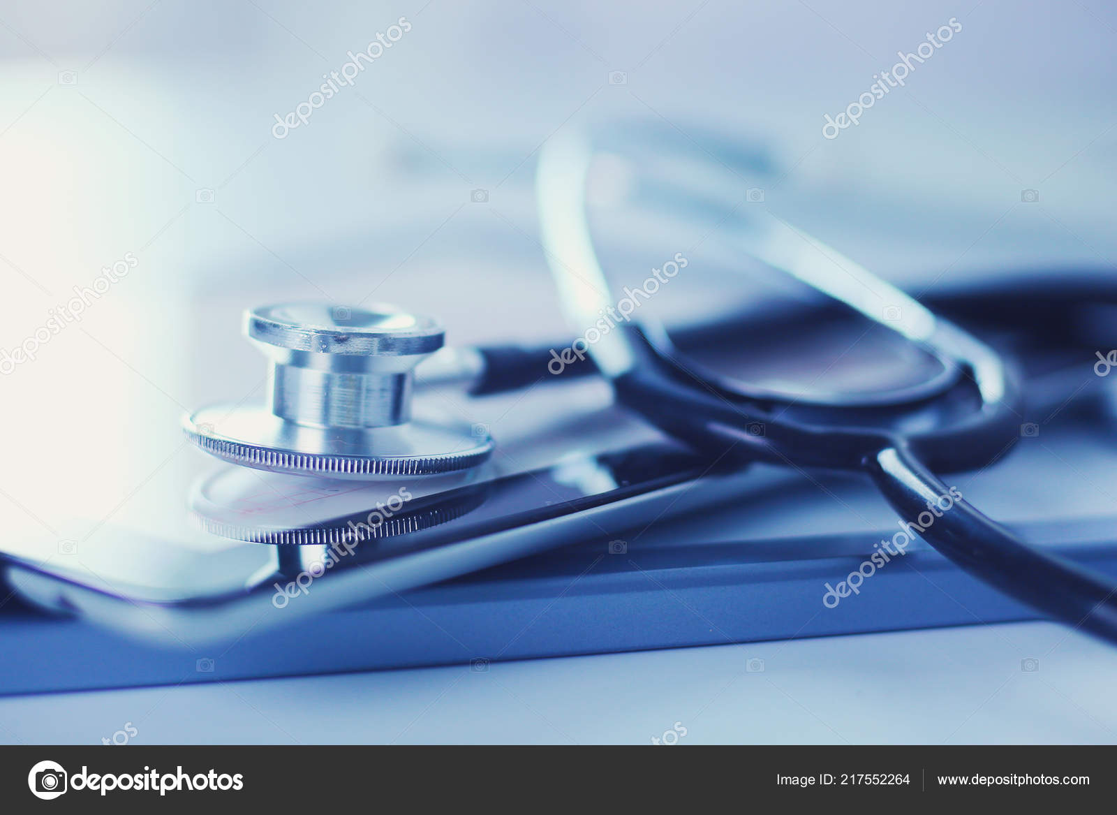 Medical equipment blue stethoscope and tablet on white background