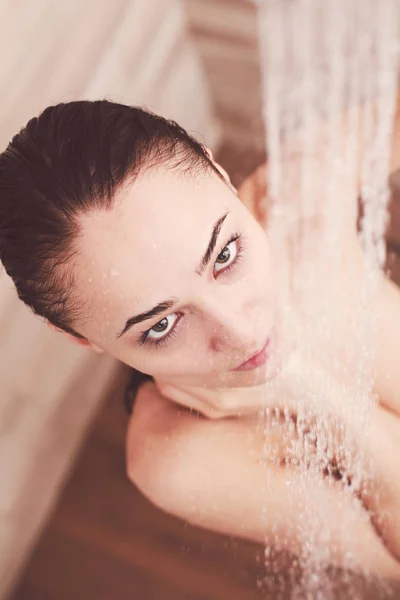 Young beautyful woman under shower in bathroom. — Stock Photo, Image