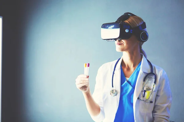 Female doctor wearing virtual reality glasses isolated on white background.