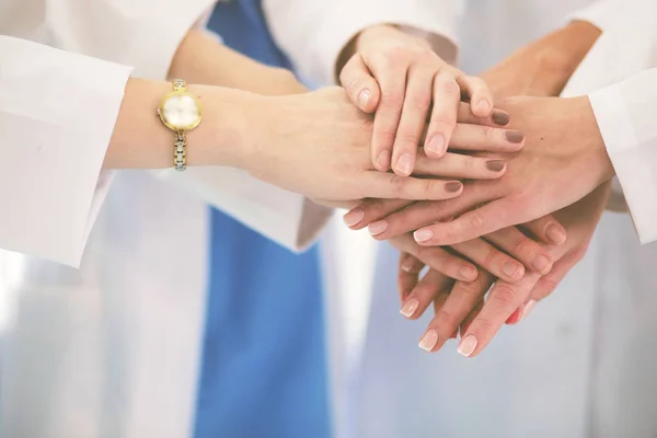 Médicos e enfermeiros em uma equipe médica empilhando mãos. — Fotografia de Stock