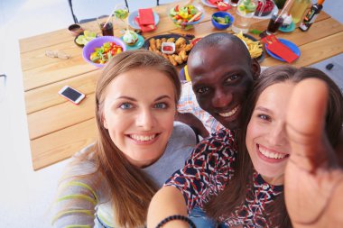 Öğle yemeği sırasında selfie çeken bir grup insan. Kendim. Arkadaşız. Arkadaşlar yemek yerken fotoğraflanır.