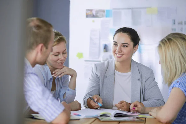 Young people studying with books on desk. Beautiful women and men working together. — Stock Photo, Image